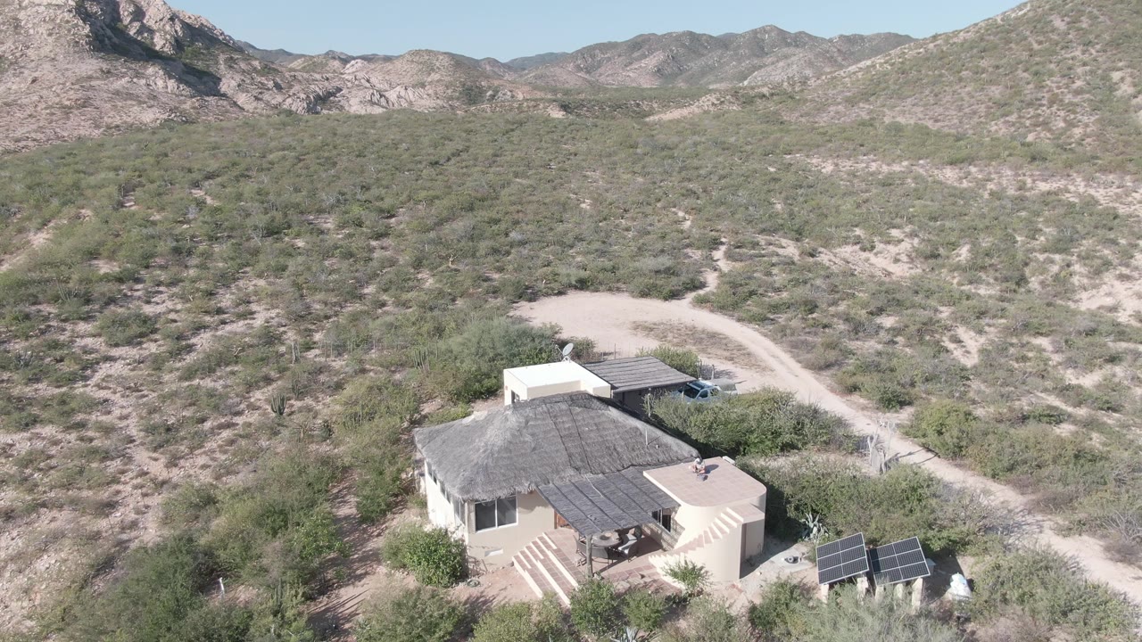 Drone view above a desert house and unpaved road