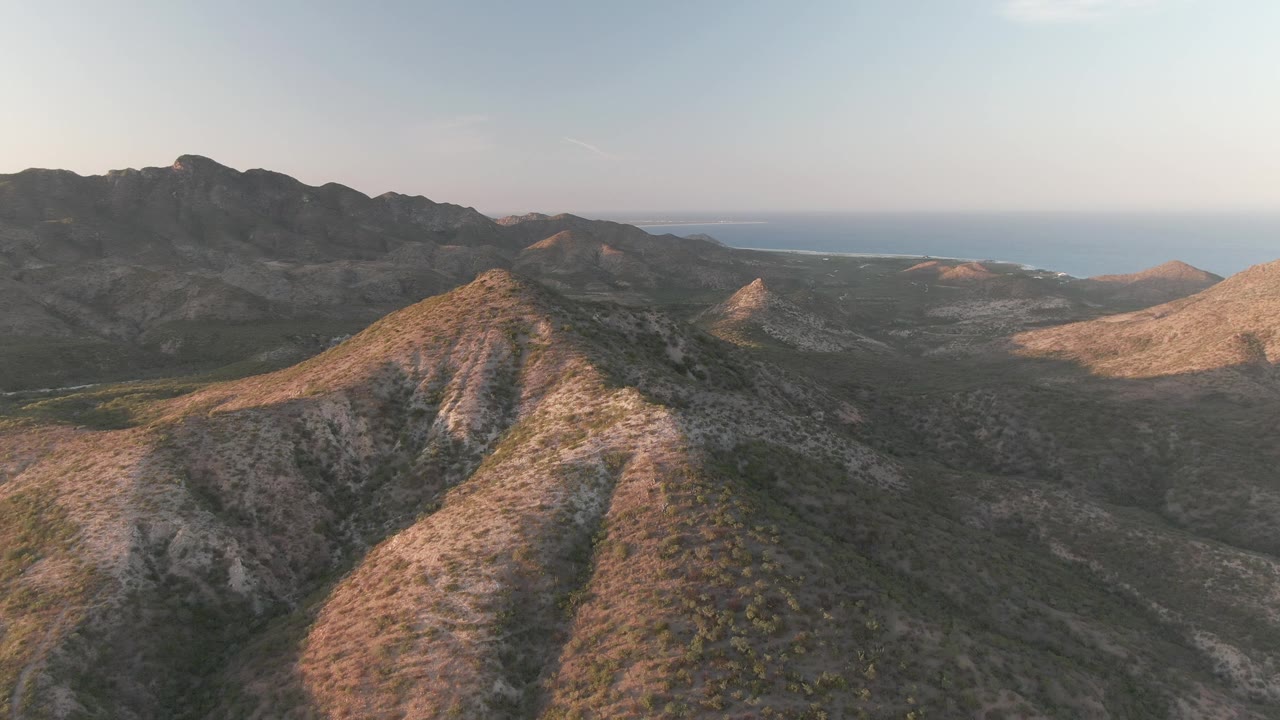Aerial mountain landscape with shadowed valleys