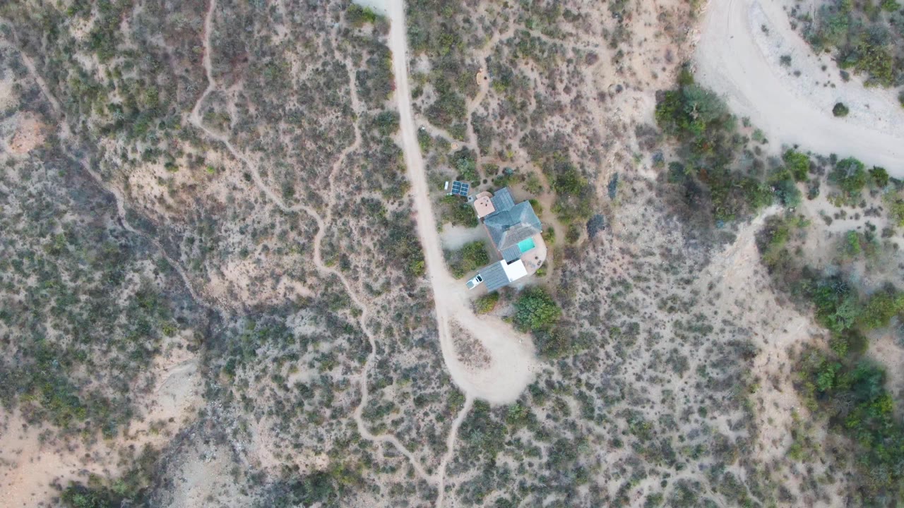 Small desert structure with road and scattered scrub.