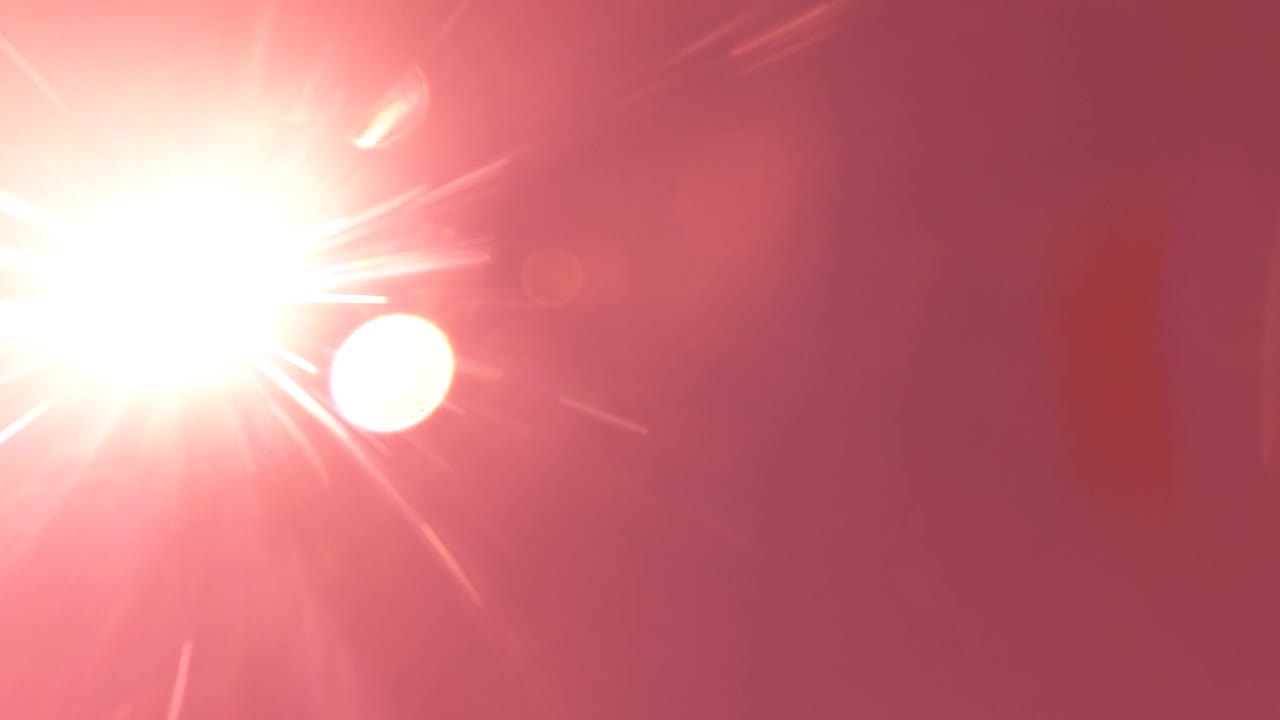 At 0:01, the overexposed sun burns into the upper left of the San Jose del Cabo sky as a round white moon shape appears lower and to the right, with no visible people.