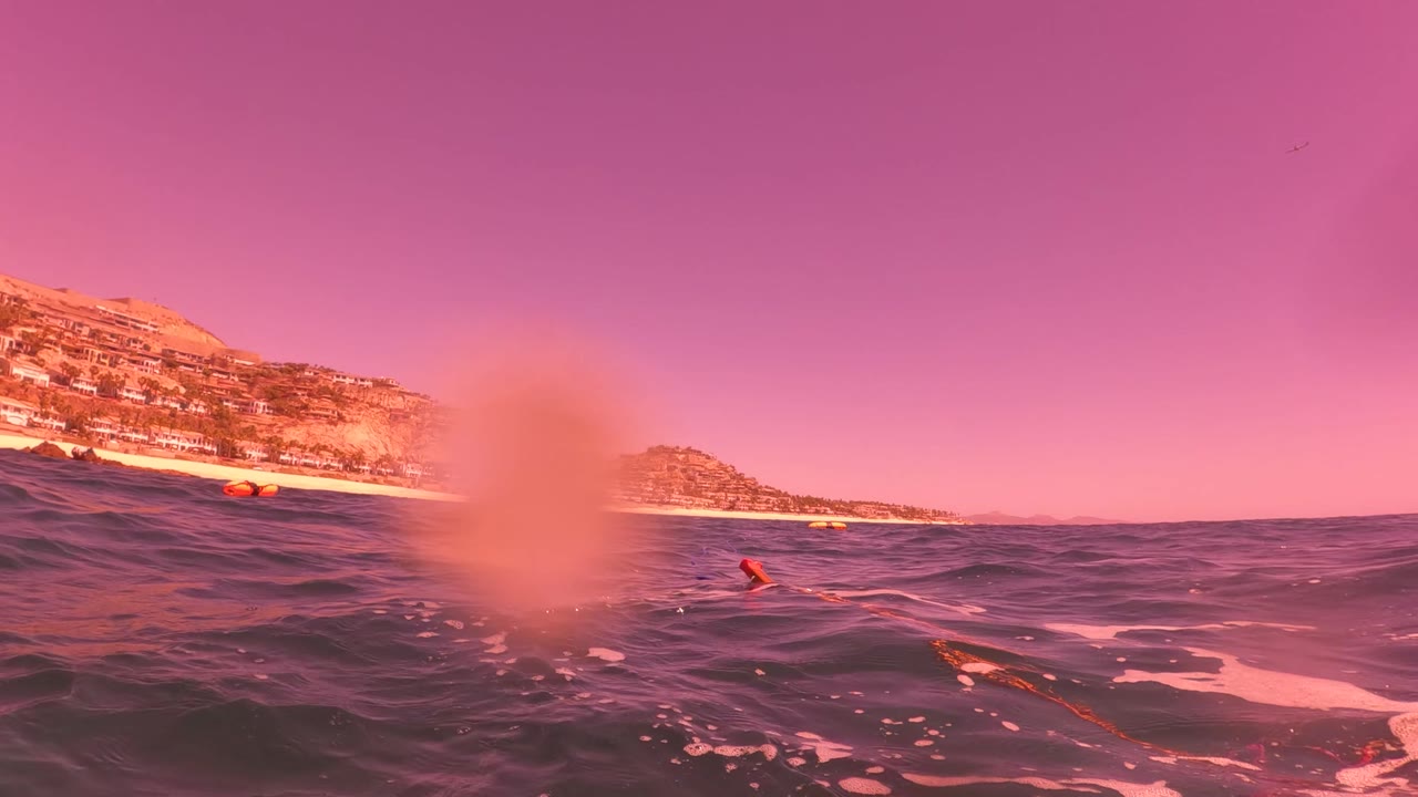 Ocean surface with coastline and water blur on the lens
