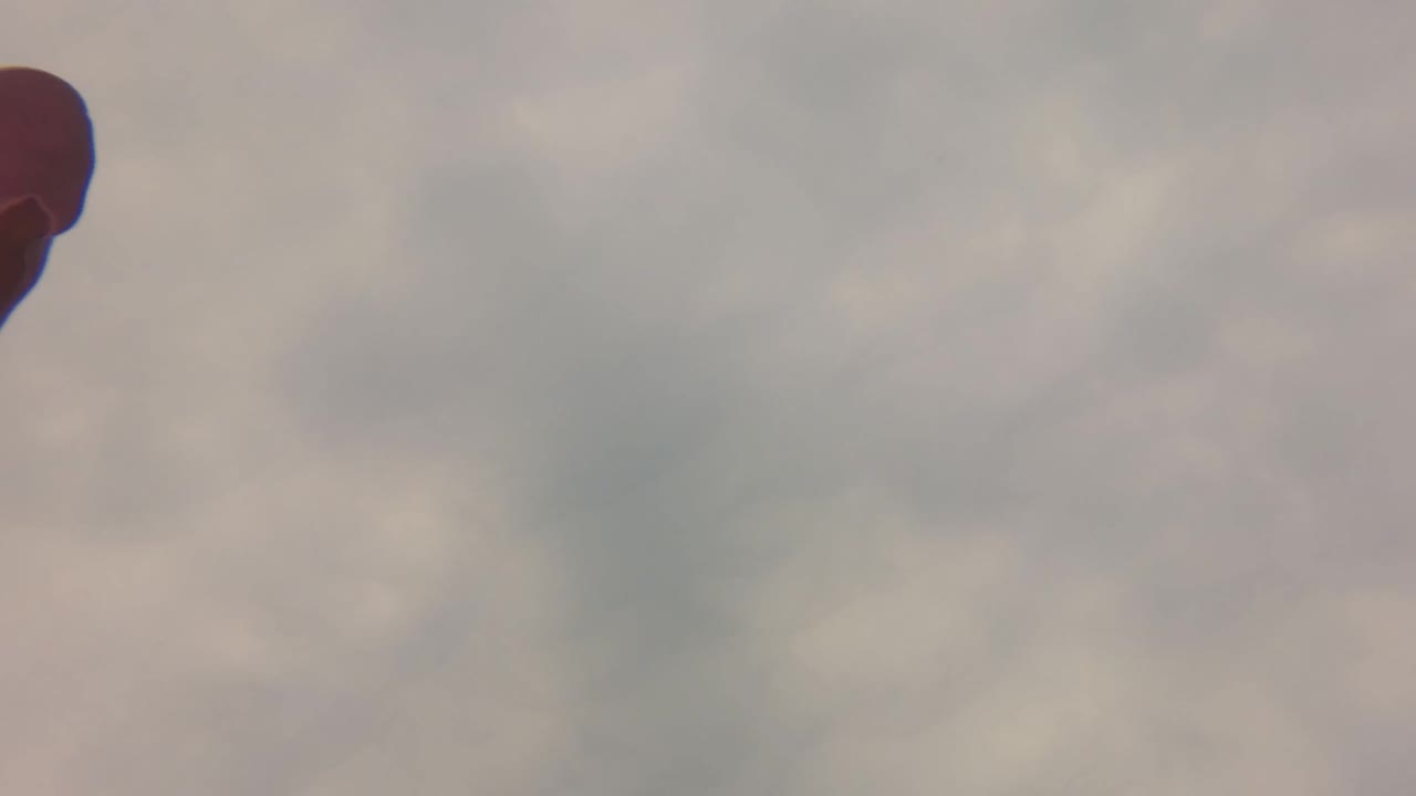 At 0:00, a partial dark gloved hand touches the far left edge of a blurred San Jose del Cabo water-surface frame, with no visible people.