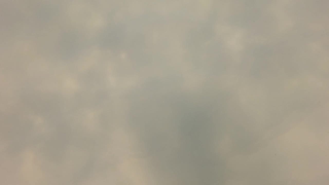 Mid-early San Jose del Cabo frame showing cloudy shallow water with faint dappled highlights, floating silt, and no visible people.
