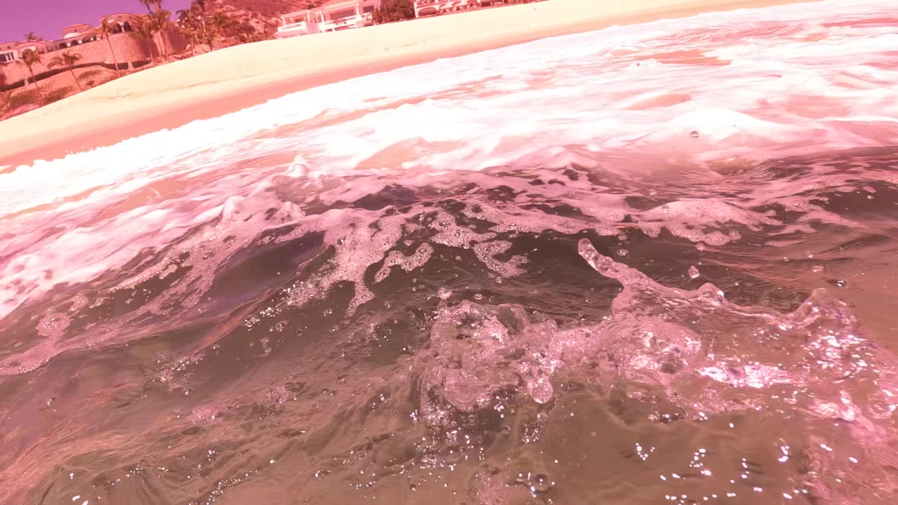 Breaking shore wave with beach edge at the top left