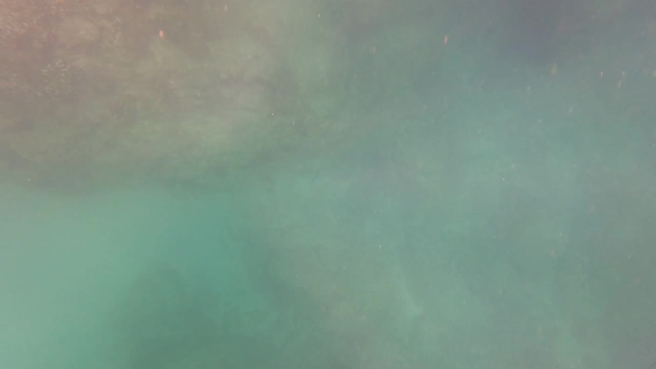 Turquoise underwater view over a rocky seabed