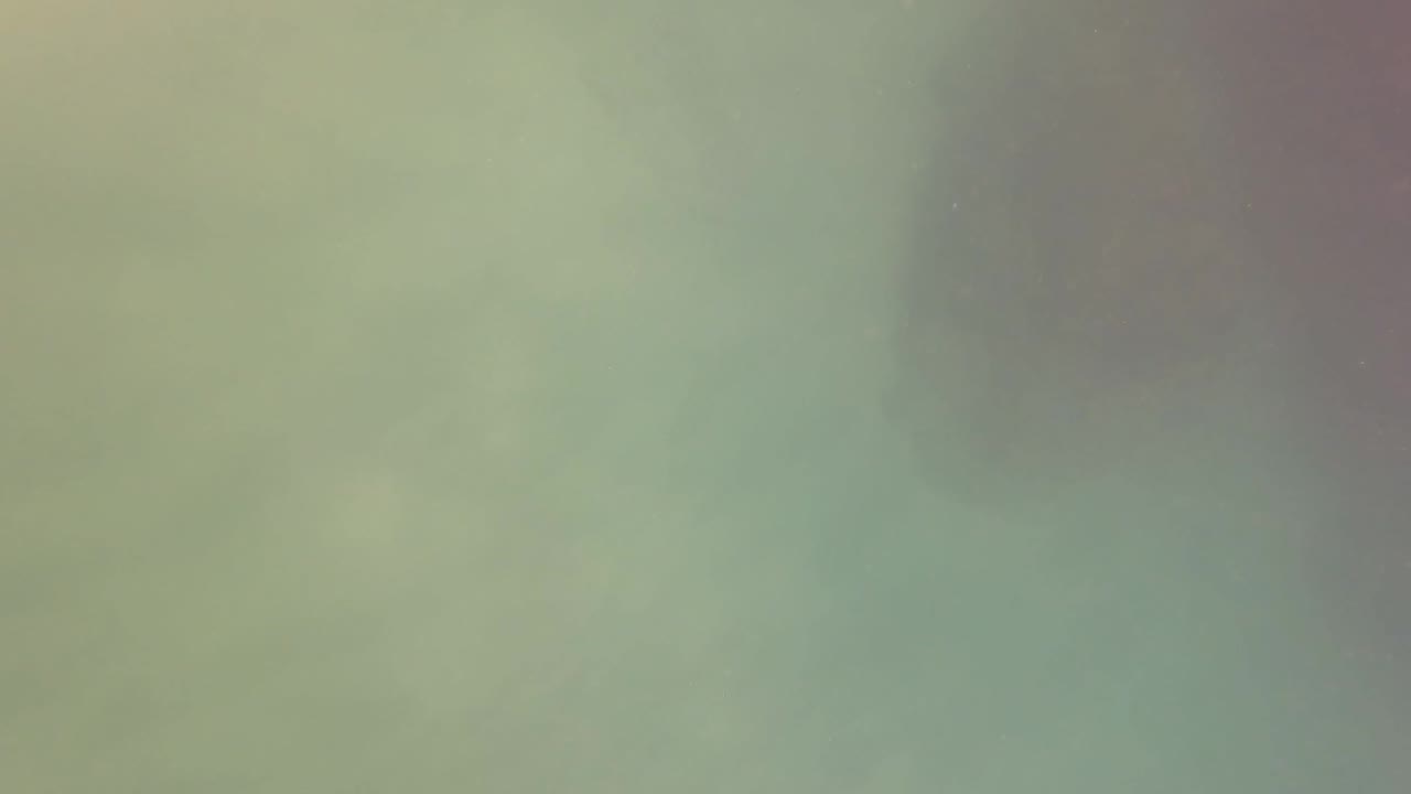 Soft green underwater haze in San Jose del Cabo with faint suspended particles and no visible people.