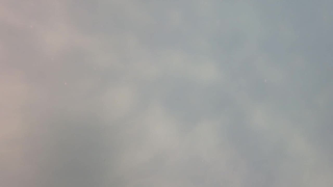 Soft out-of-focus gray clouds fill the San Jose Del Cabo sky at the start of the clip, with faint pink tinting on the left and no visible people.