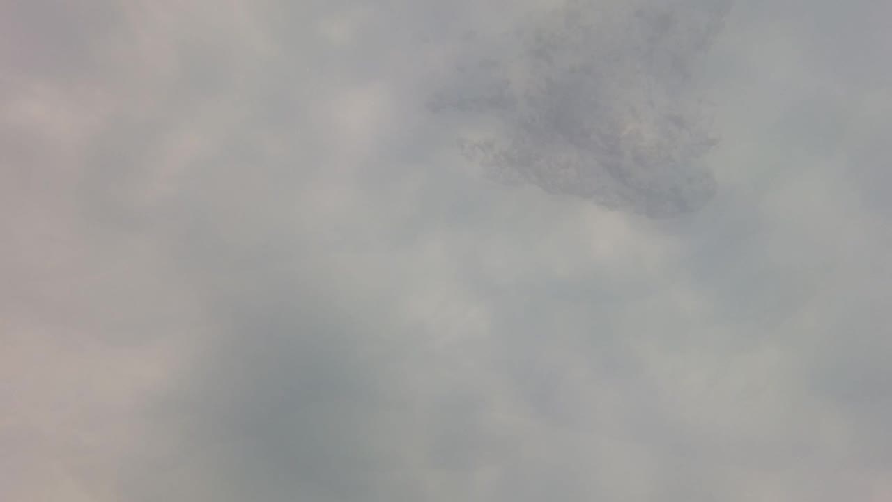 Cloudy underwater view with faint small fish shapes