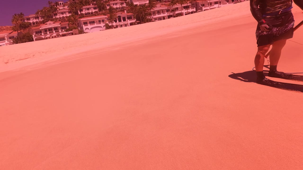 Tilted view of sandy slope with person partly visible at the right edge.