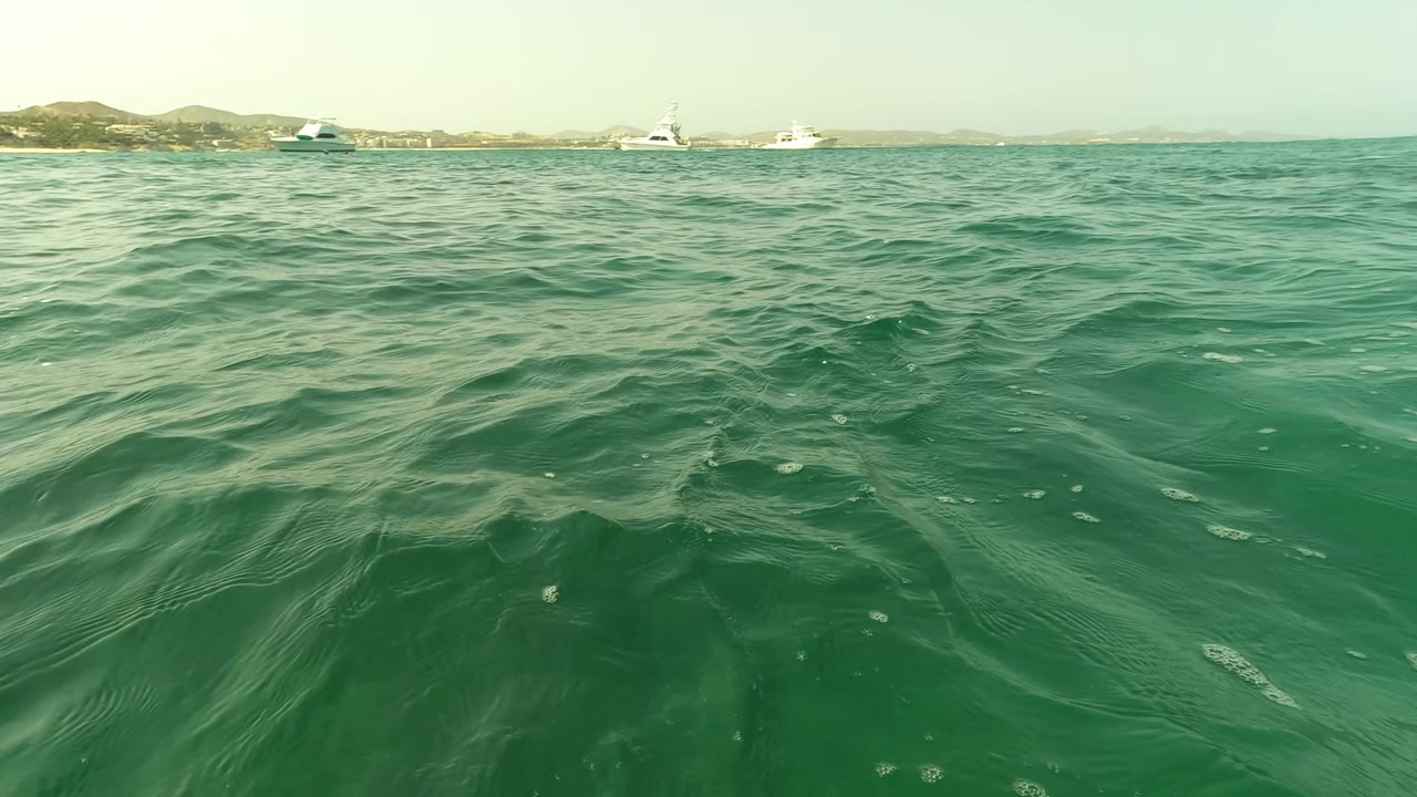 Open water with distant boats near the coast