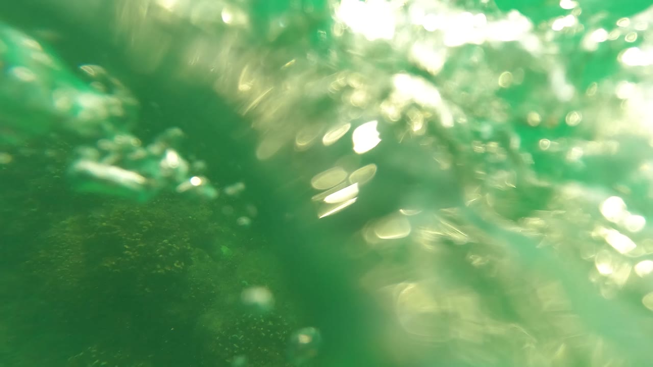 Blurred underwater surface light over green water