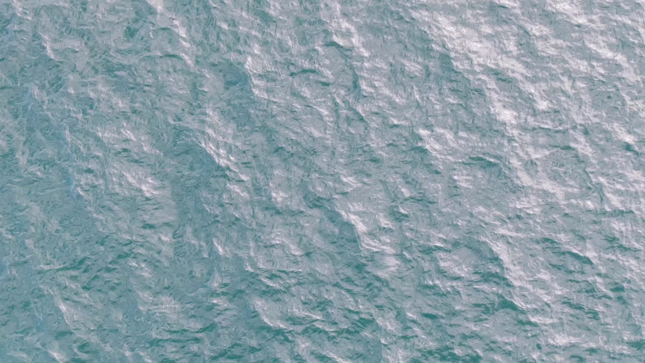 Turquoise ocean surface at Shipwrecks, Baja California Sur, with fine ripples spread across the frame and no visible people.