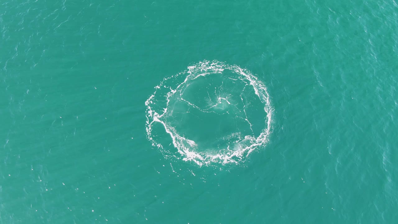 At Buzzards Beach in Baja California Sur, the circular splash remains visible but thinner, surrounded by open turquoise sea and no visible people.