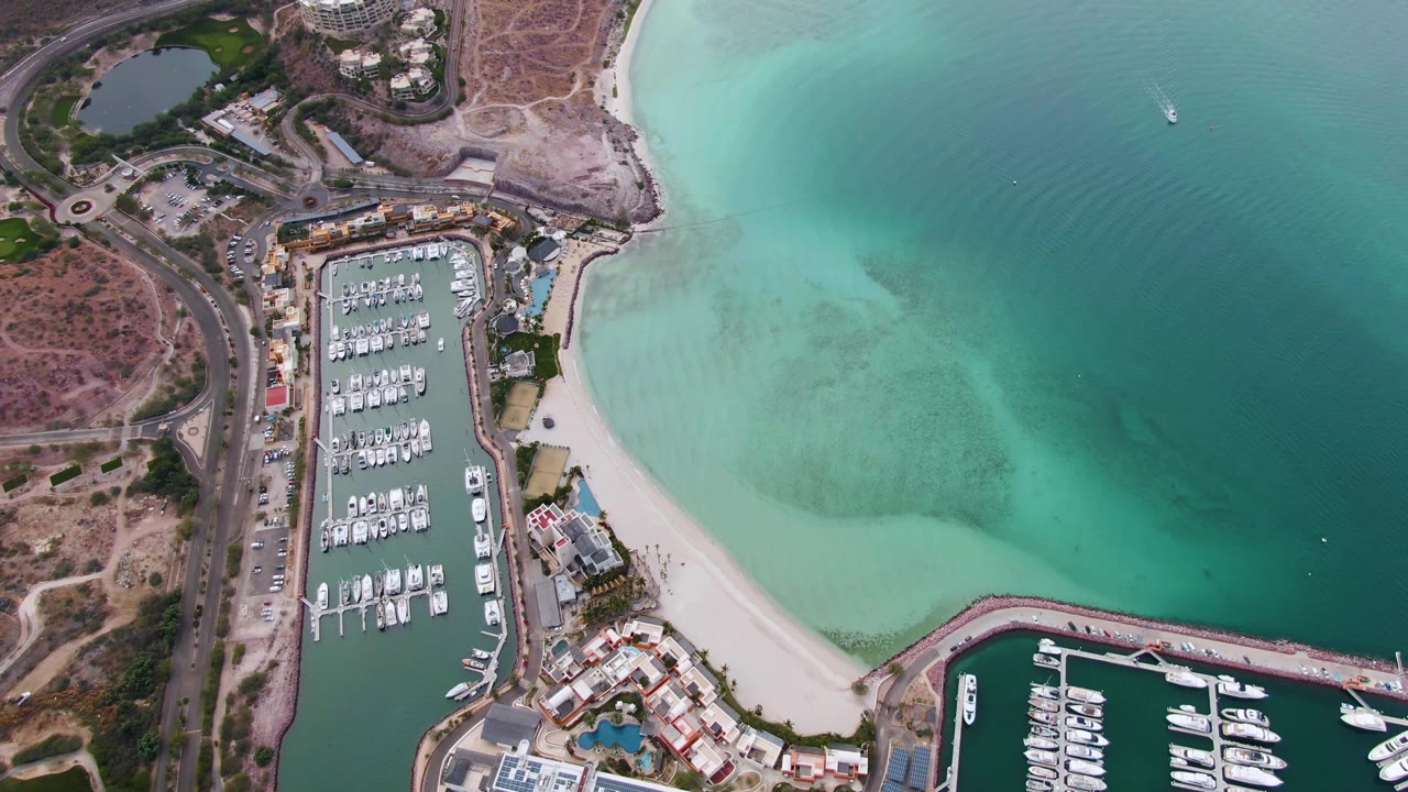 Coastal marina with beach and open turquoise water