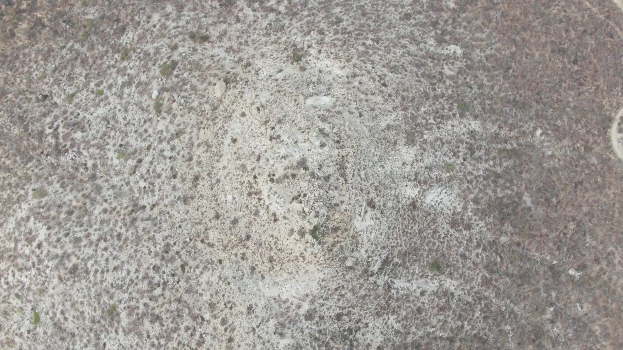 Overhead view of arid scrubland near Punta Gorda Beach, Baja California Sur, with pale sandy patches and no visible people.