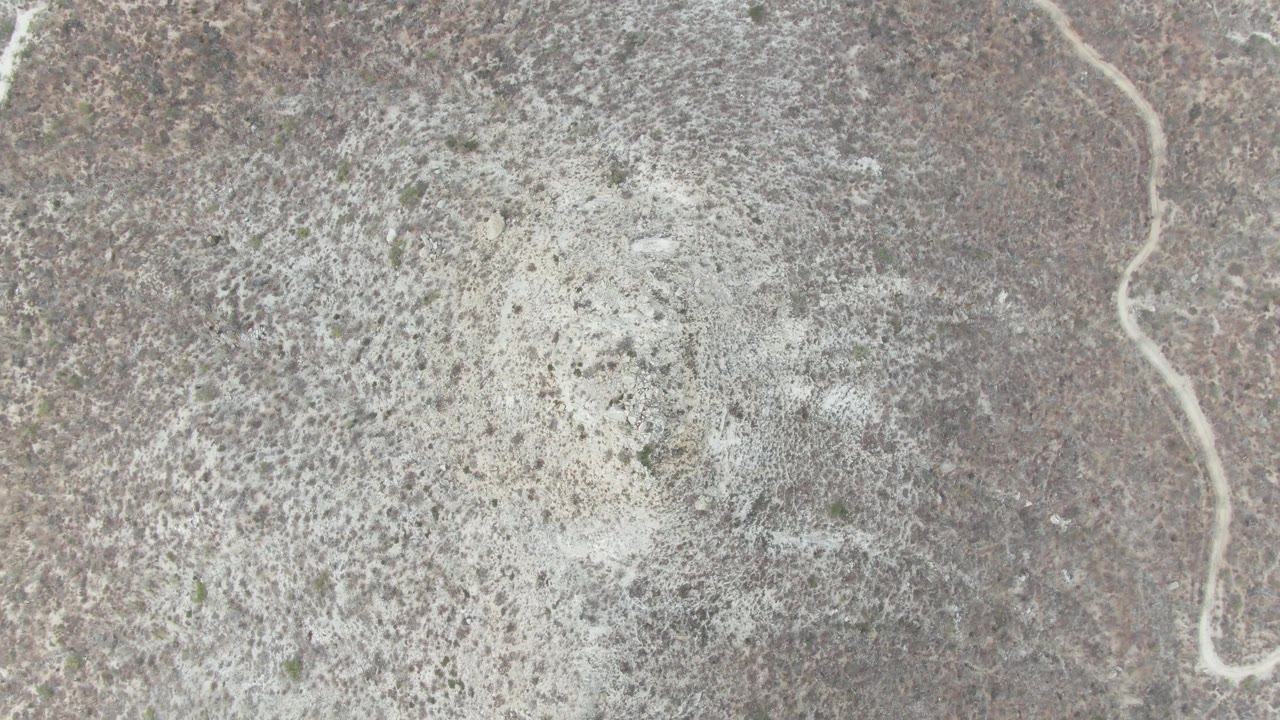 Arid plain with dry wash crossing the frame