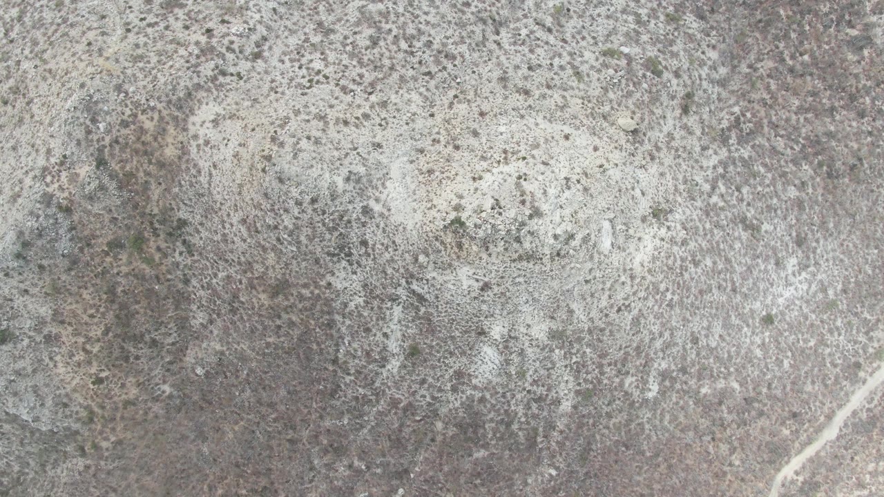 At two seconds, the Punta Gorda Beach surface shows a faint pale diagonal mark near the lower right against gray-white speckled stone, with no visible people.