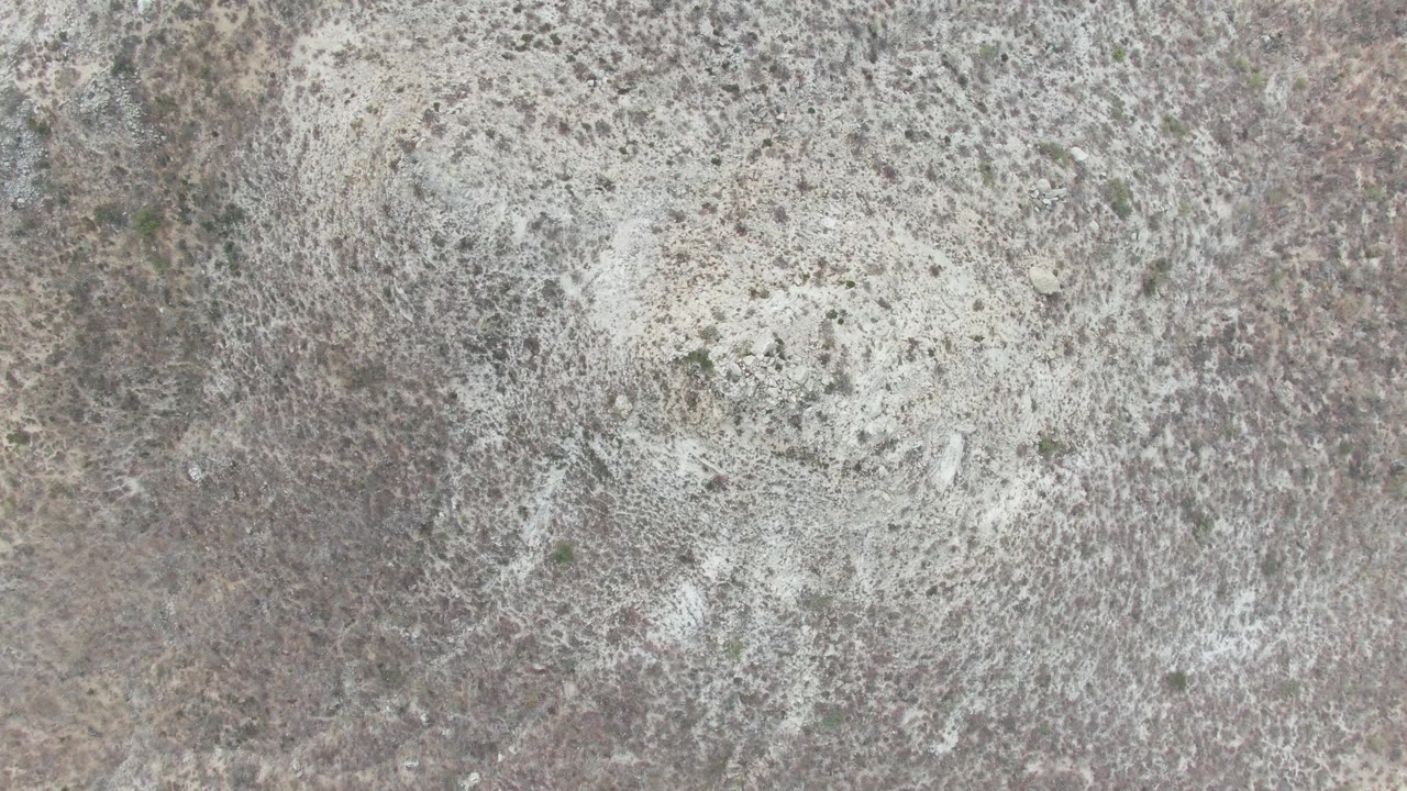 Second frame showing white cleaning foam extending across the speckled stone surface at Punta Gorda Beach BCS, with no visible people.