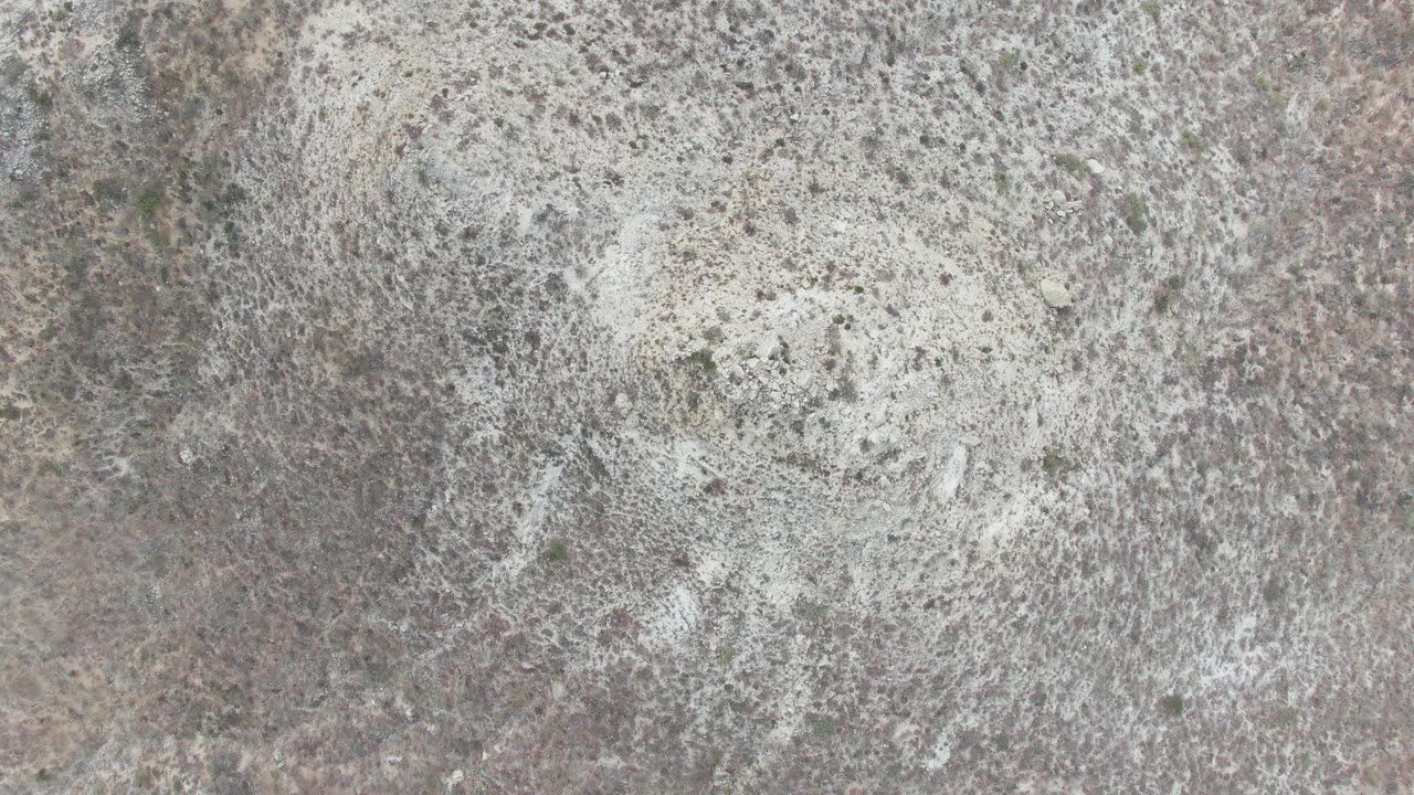 Third frame of the Punta Gorda Beach BCS stone surface with pale foam over gray, tan, and green-speckled rock texture, and no visible people.
