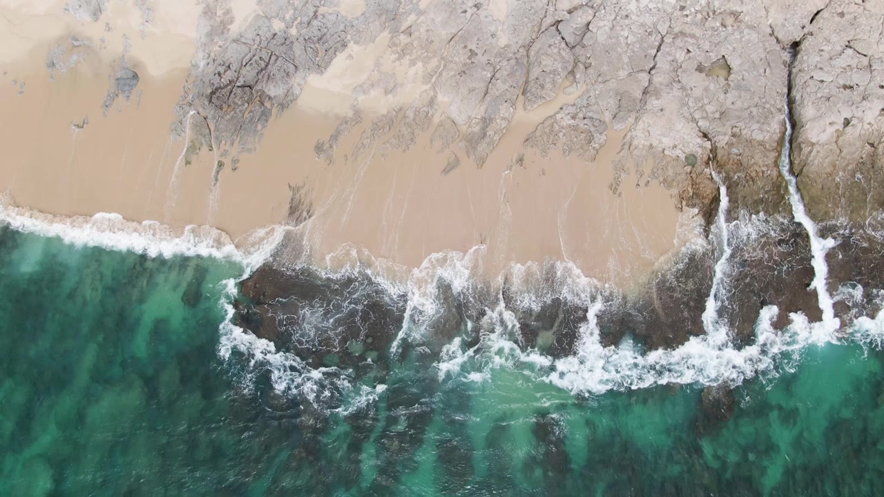 Foam breaking over rocky shoreline