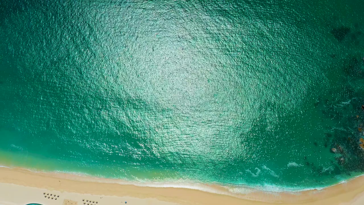 Turquoise sea and beach seen from directly overhead