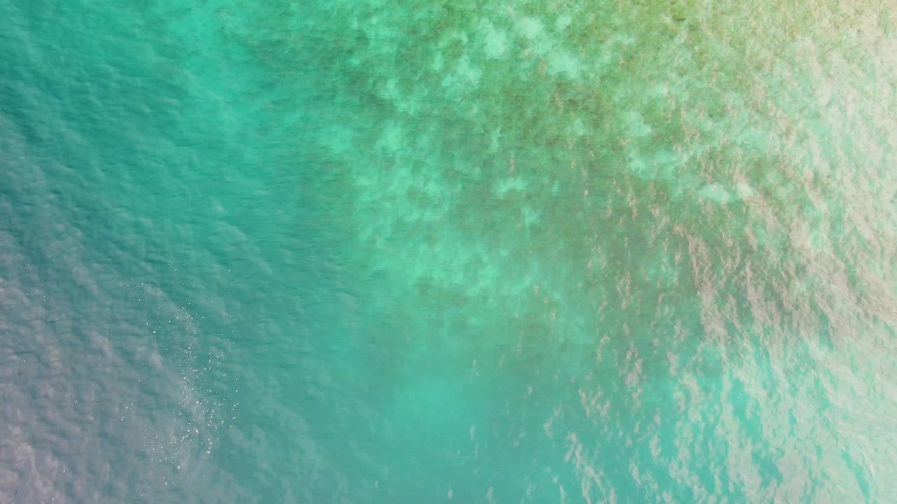 Overhead turquoise shallow water with sunlit ripples