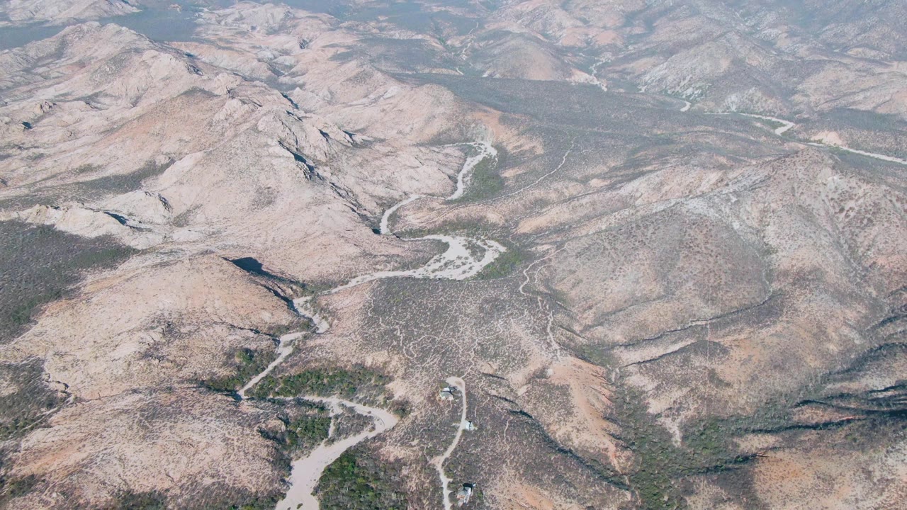 Aerial view of dry rocky ridges with winding dirt paths