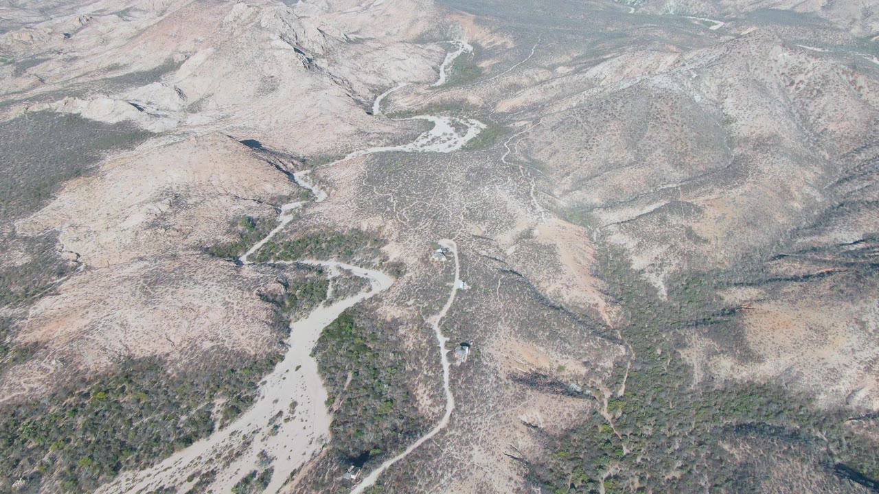 High aerial view of road bends in barren hill country