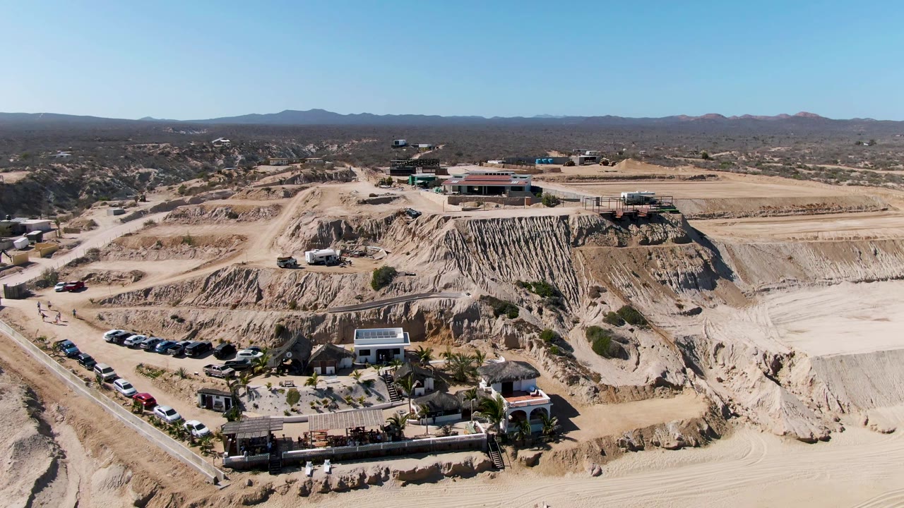 Third frame holds a broad La Fortuna quarry composition with a larger pale excavation floor on the right, buildings near the upper cut, a parking line below, and no visible people.