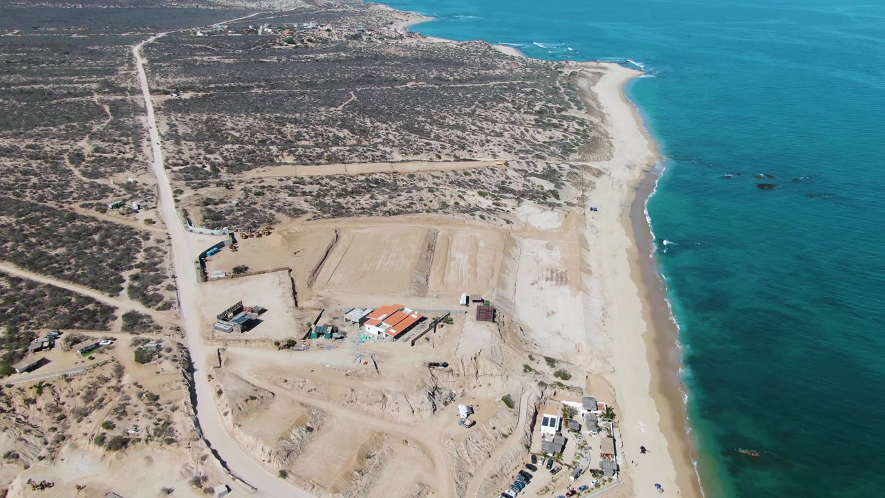 Third frame shows La Fortuna beach from above with turquoise water on the right, scrubland and roads inland, construction equipment and sand piles below, and tiny beachgoers near the surf line.