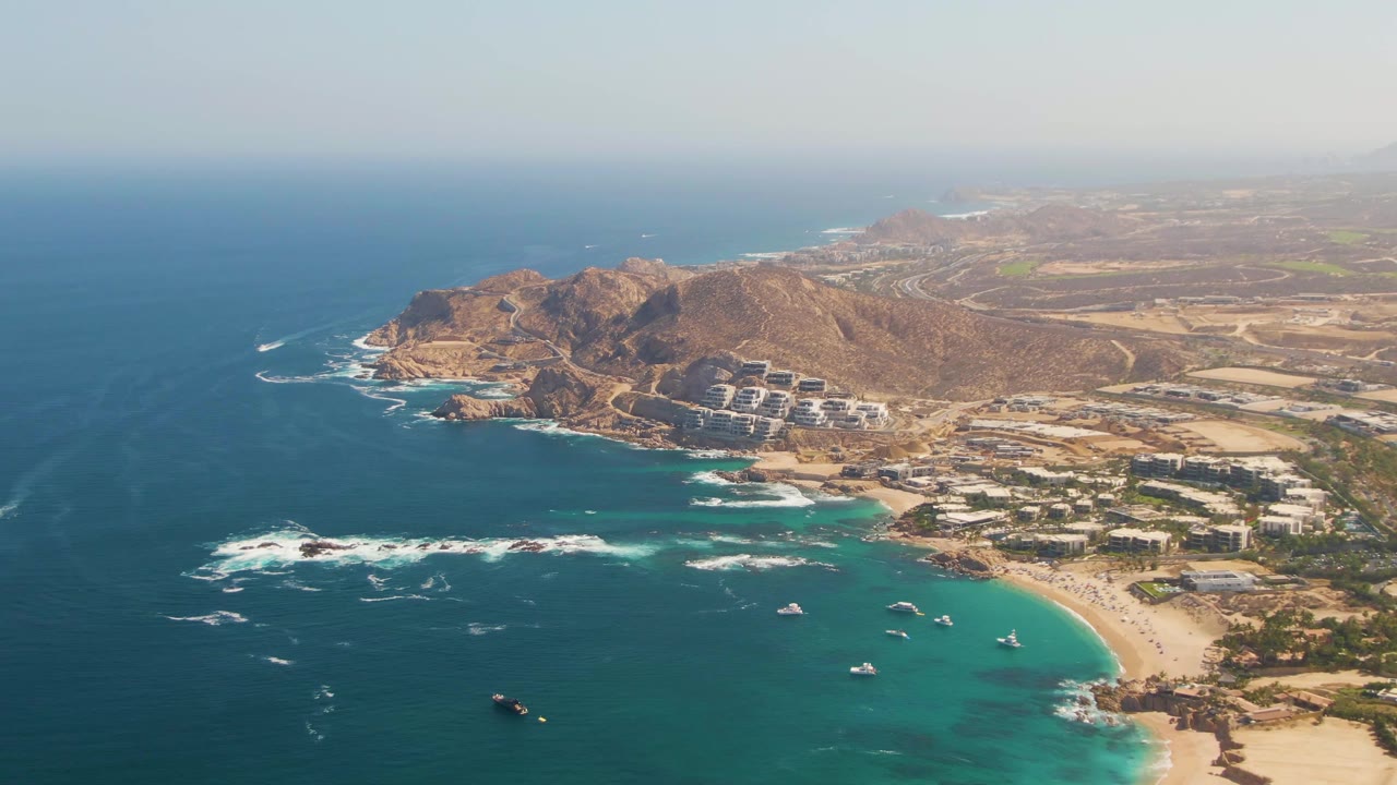 Third frame shows El Tule Beach from above, with the sandy curve of the shore more visible, several small boats offshore, white foam on rocks, and no visible people.