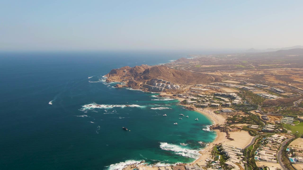 The second frame shows El Tule Beach from above with a white boat leaving a wake offshore, surf breaking near rocks, beach buildings along the sand, and no visible people.