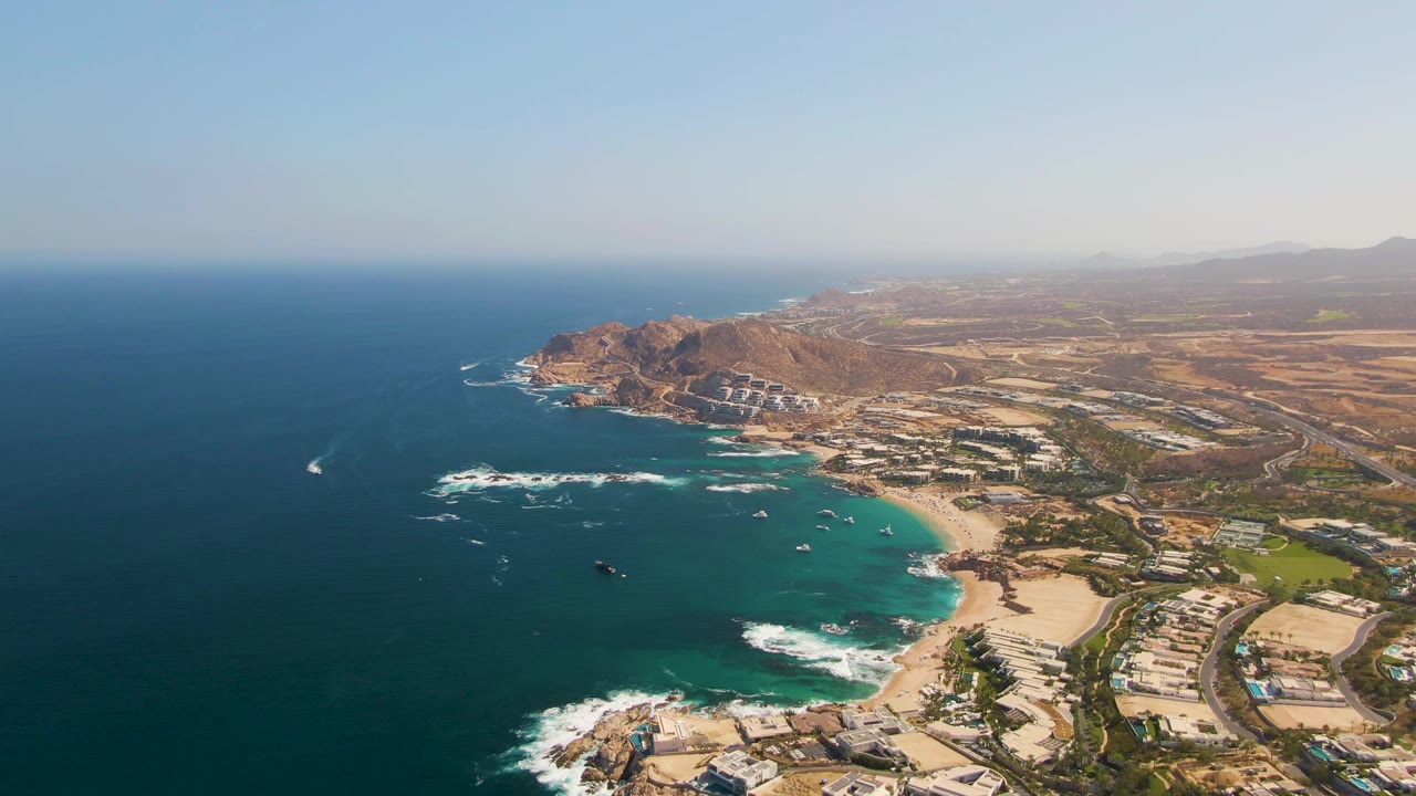 The fourth frame shows El Tule Beach with more open ocean in the left foreground, white waves crossing dark rocks, the sandy cove below, shoreline buildings at right, and no visible people.
