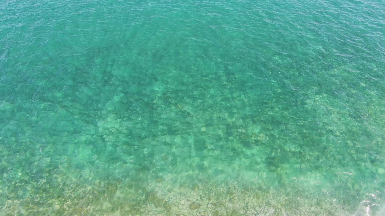 Turquoise shallow ocean water over a visible seabed