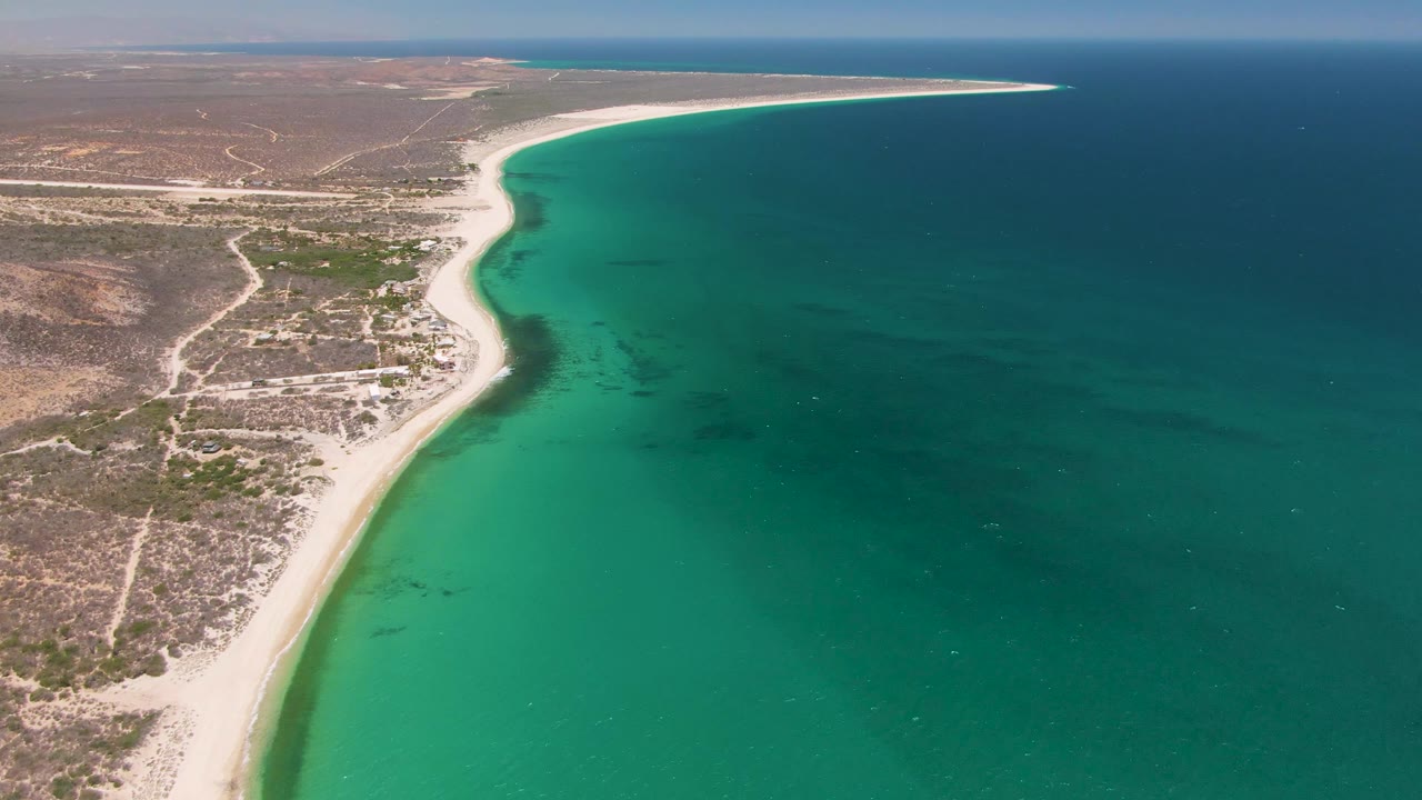 Aerial coastline with turquoise water and arid land