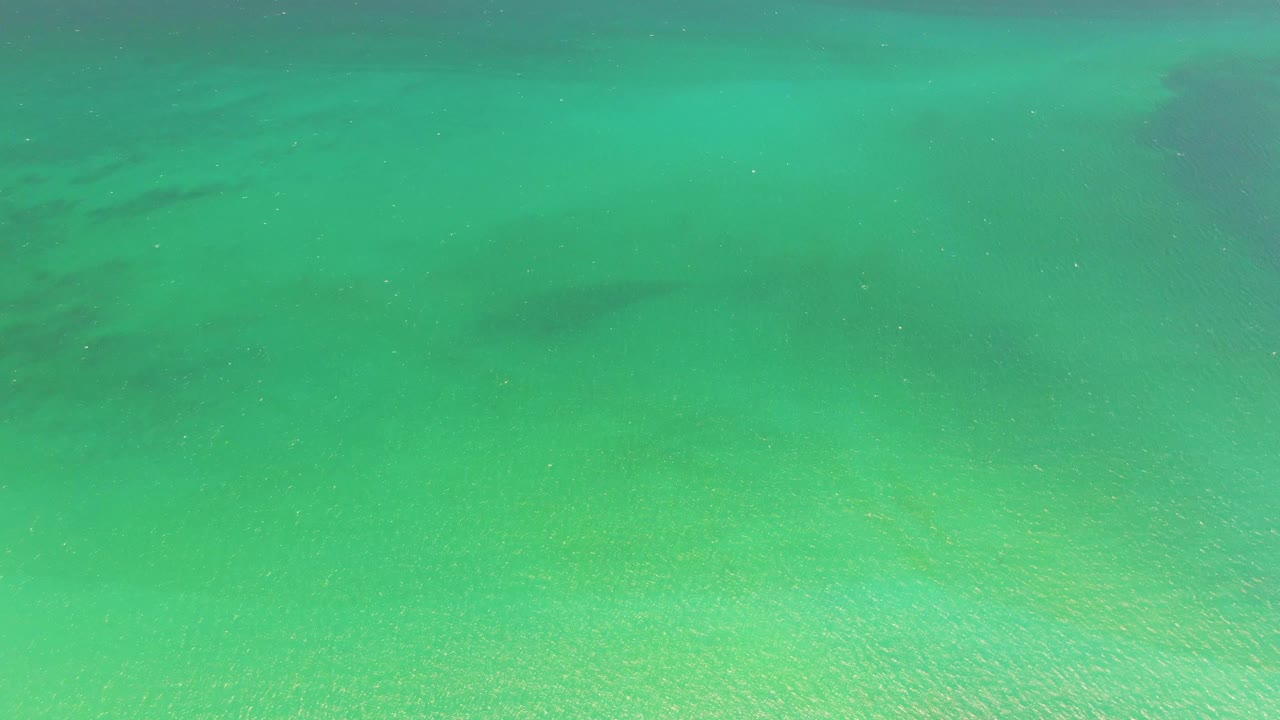 Underwater turquoise scene with pale sand and soft shadows