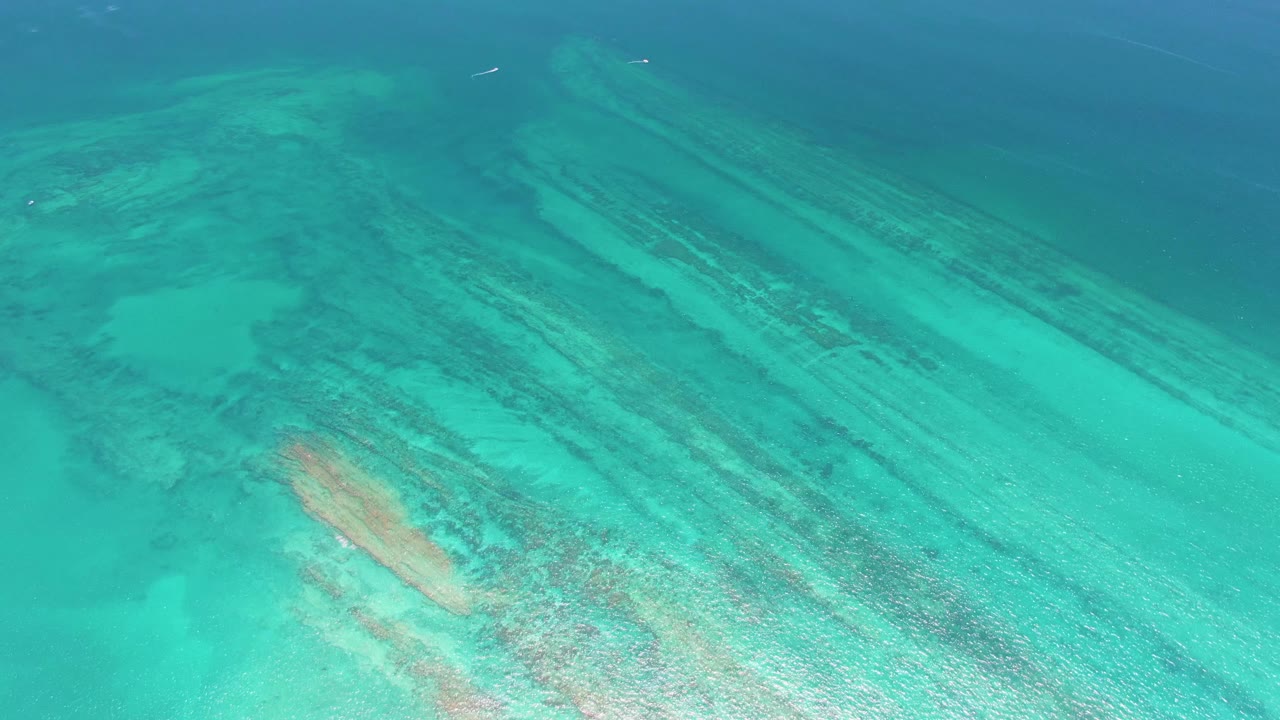 Turquoise water over a shallow coral reef and seabed