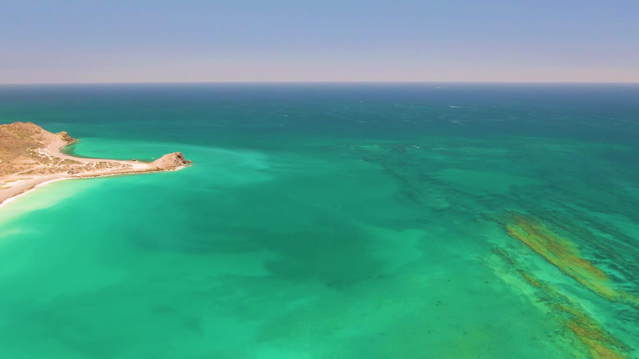Third frame shows Cabo Pulmo from above with the headland and beach tucked into the upper left, green-blue shallows across the center, darker offshore water, and no visible people.