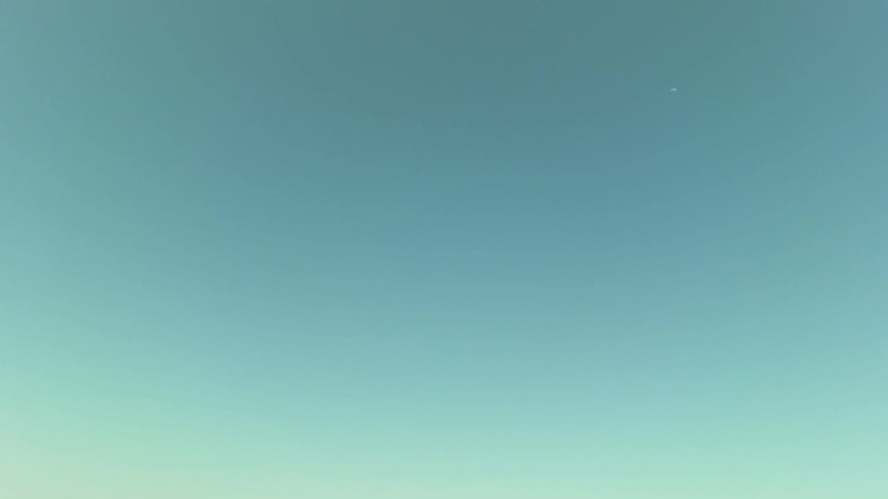 Opening frame of green ocean water and pale blue sky in Los Barriles, Baja California Sur, Mexico, with no visible people and no shoreline detail in view.