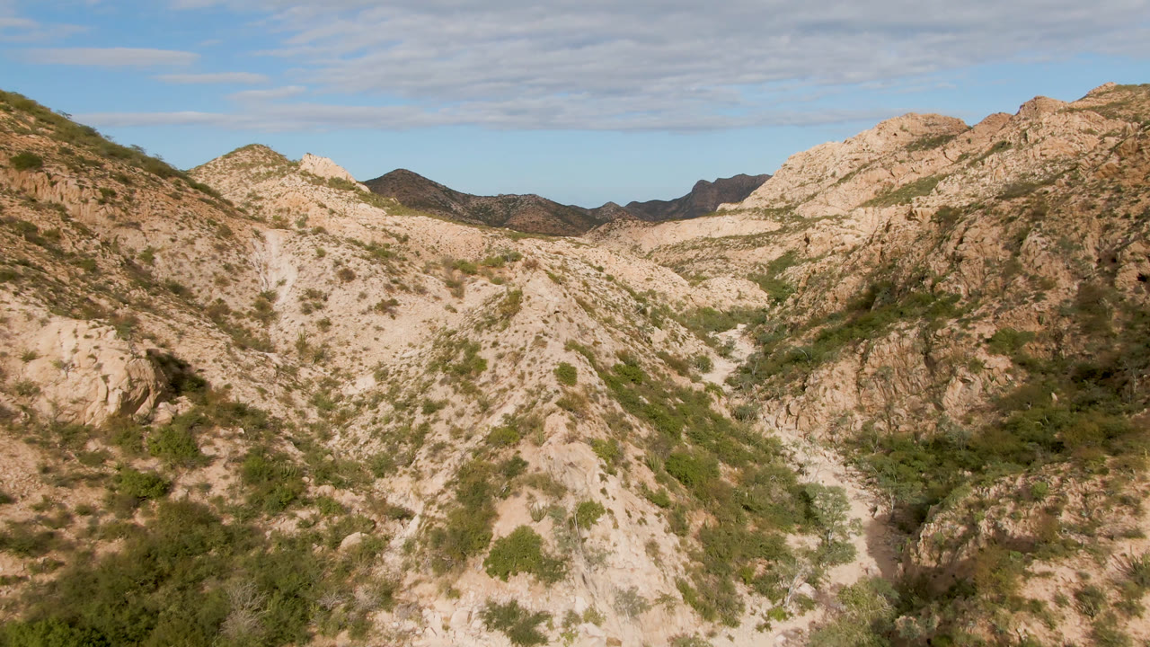 Rocky mountain valley with pale slopes and desert brush