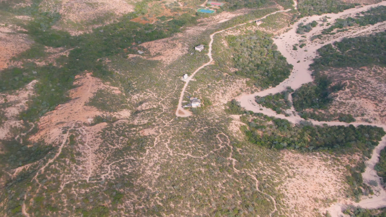 Aerial view of winding dirt roads across dry scrubland