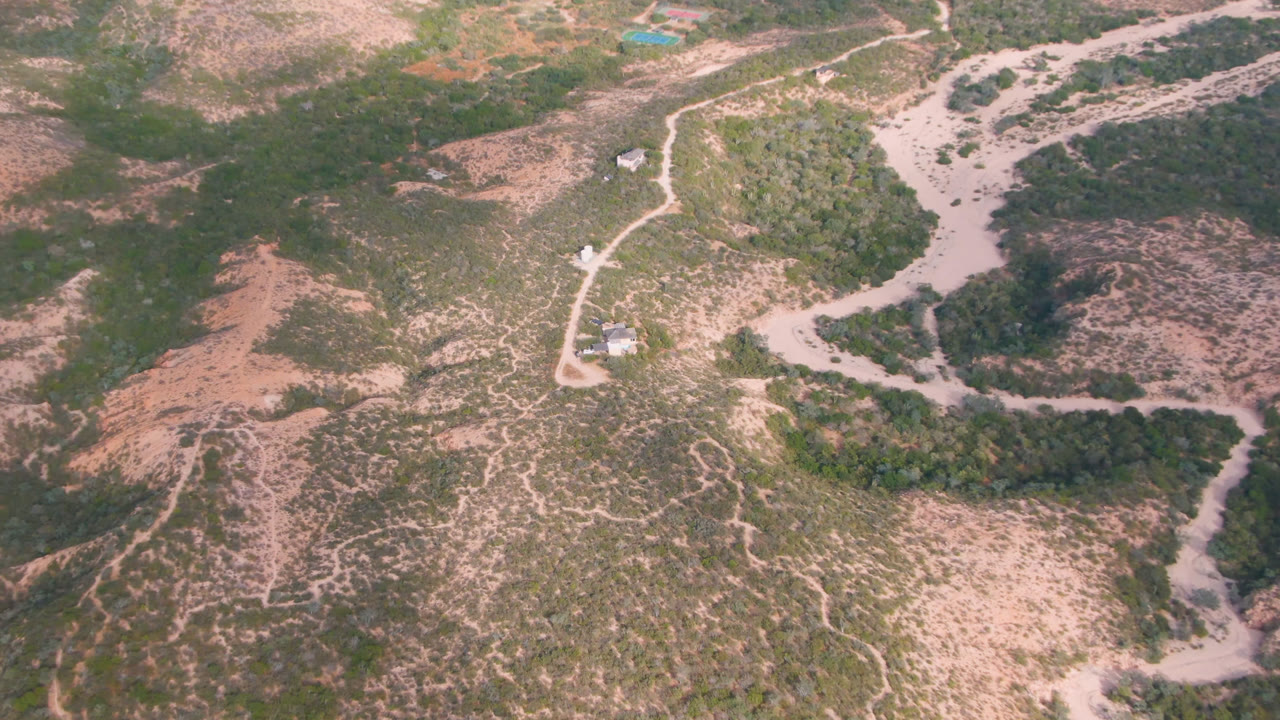 Drone view of a winding road through arid terrain