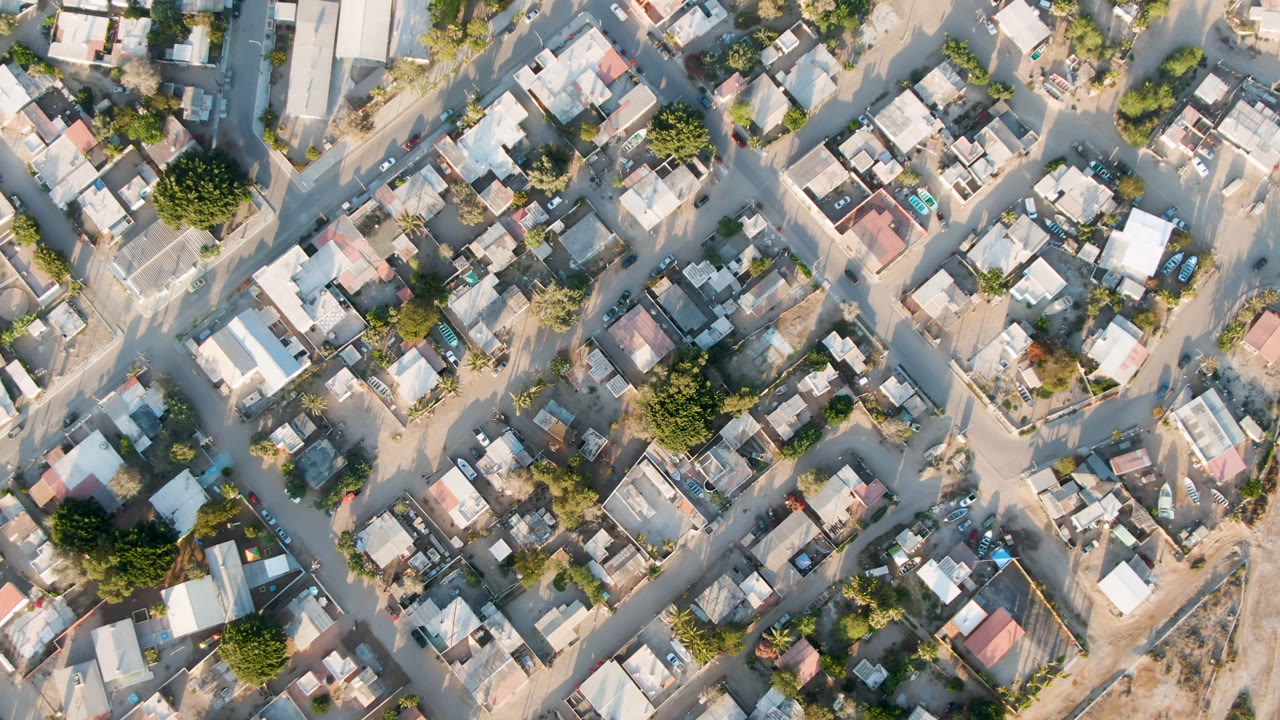 Overhead view of compact town blocks and dirt roads