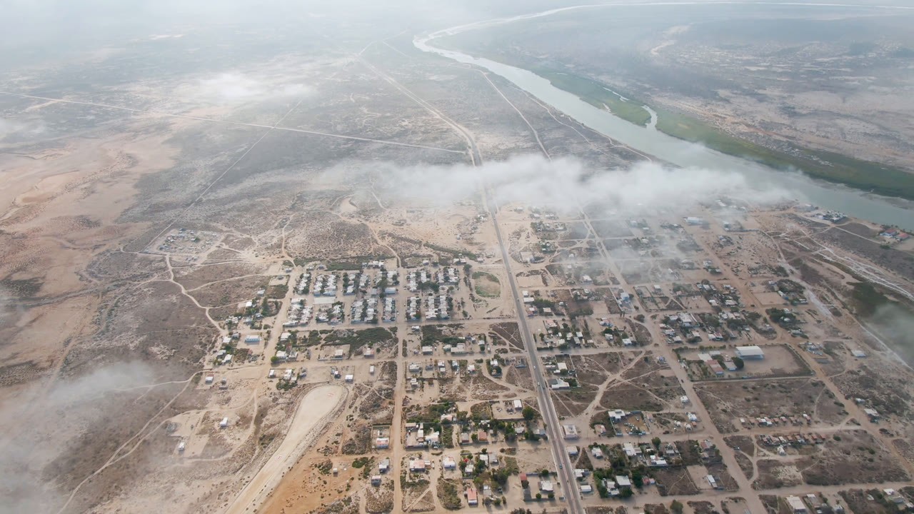 Small town and river seen from high above in hazy light