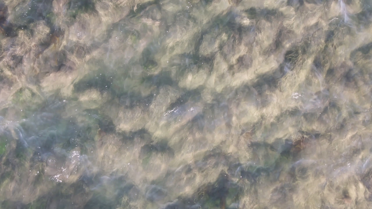 Abstract shallow coastal water with darker patches