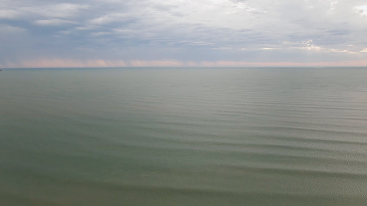 Cloudy sky over smooth open water