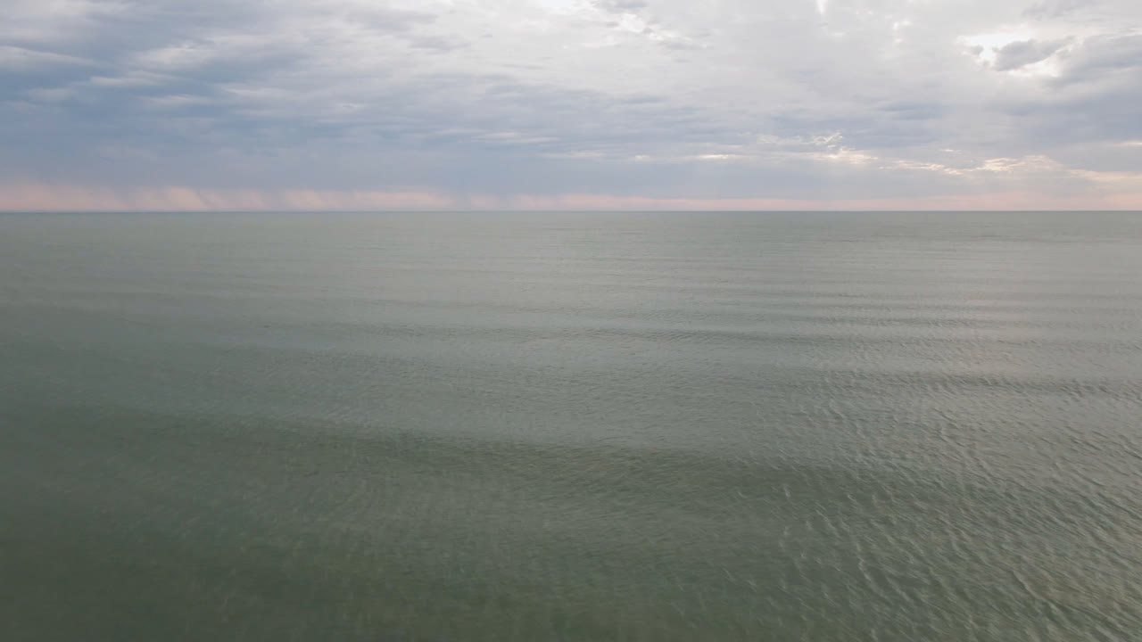 Open sea surface with cloudy sky above
