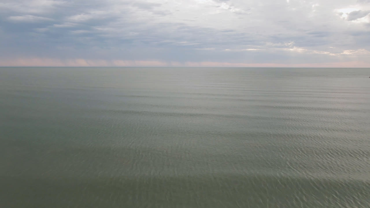 Opening frame of San Felipe, Mexico open water under a layered cloudy sky, with a level horizon and no visible people.