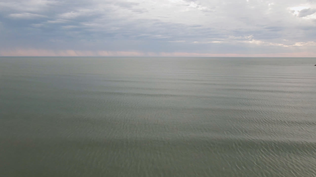San Felipe, Mexico water fills the lower frame while gray clouds sit above a thin horizon line, with no visible people.