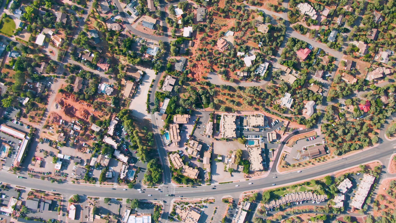 Top-down road corridor with buildings and parked vehicles
